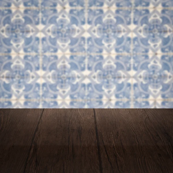 Wood table top and blur vintage ceramic tile pattern wall — Stock Photo, Image