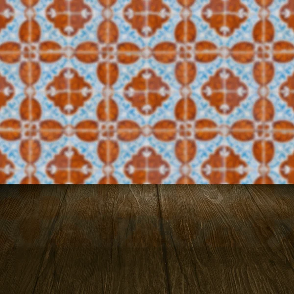 Wood table top and blur vintage ceramic tile pattern wall — Stock Photo, Image