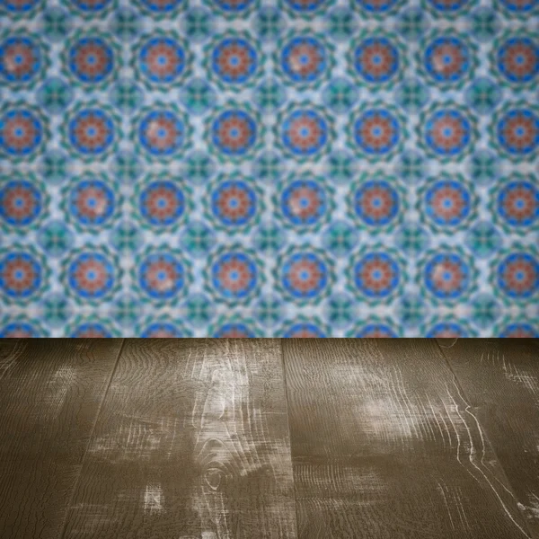 Wood table top and blur vintage ceramic tile pattern wall — Stock Photo, Image