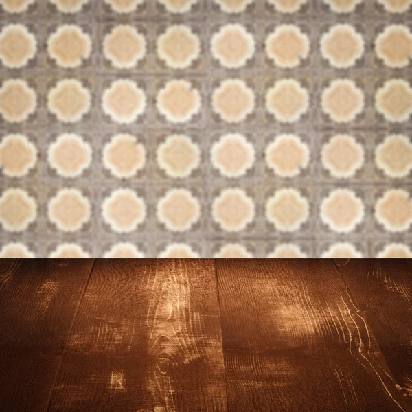 Wood table top and blur vintage ceramic tile pattern wall — Stock Photo, Image