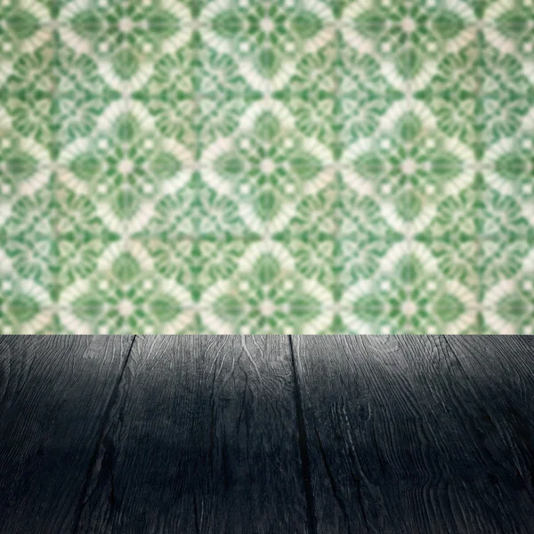 Wood table top and blur vintage ceramic tile pattern wall — Stock Photo, Image