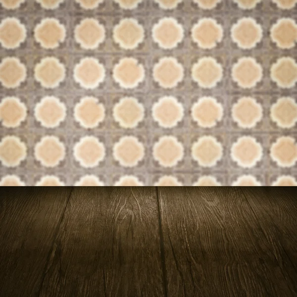 Wood table top and blur vintage ceramic tile pattern wall — Stock Photo, Image