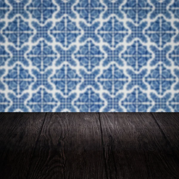 Wood table top and blur vintage ceramic tile pattern wall — Stock Photo, Image