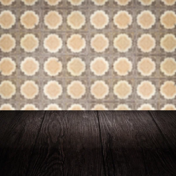 Wood table top and blur vintage ceramic tile pattern wall — Stock Photo, Image