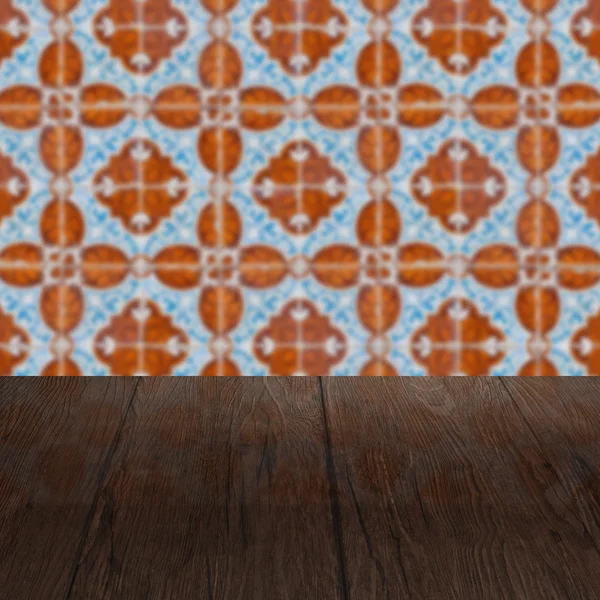 Wood table top and blur vintage ceramic tile pattern wall — Stock Photo, Image