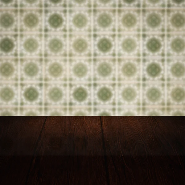 Wood table top and blur vintage ceramic tile pattern wall — Stock Photo, Image