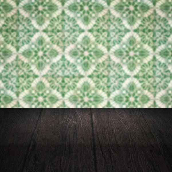 Wood table top and blur vintage ceramic tile pattern wall — Stock Photo, Image