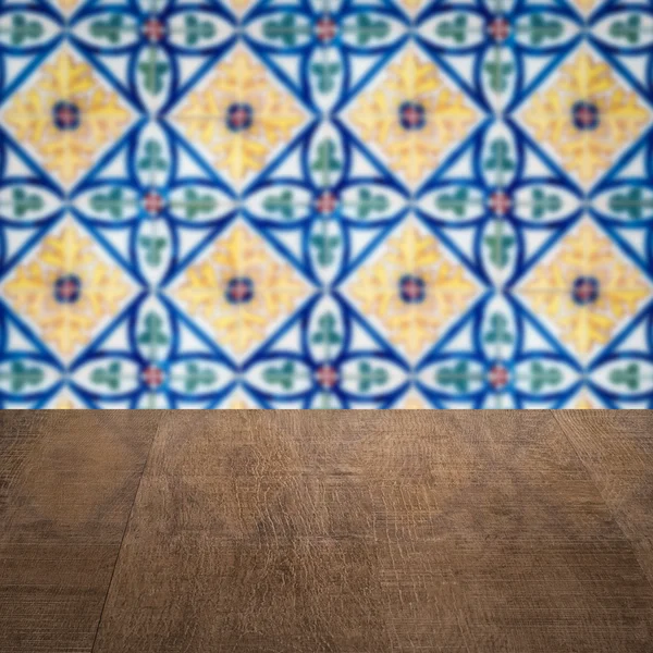 Wood table top and blur vintage ceramic tile pattern wall — Stock Photo, Image