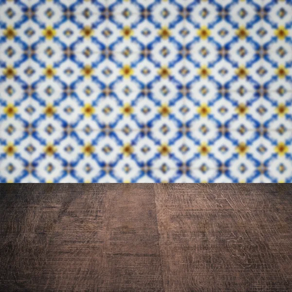 Wood table top and blur vintage ceramic tile pattern wall — Stock Photo, Image