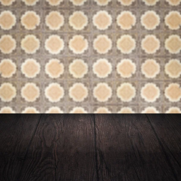 Wood table top and blur vintage ceramic tile pattern wall — Stock Photo, Image