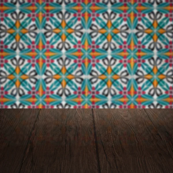 Wood table top and blur vintage ceramic tile pattern wall — Stock Photo, Image