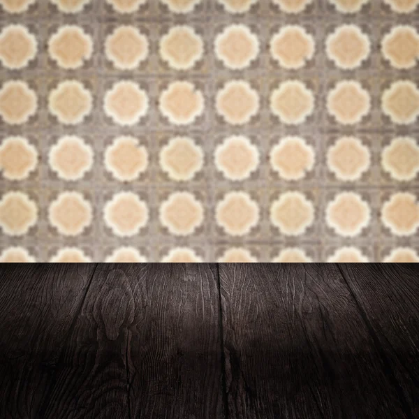 Wood table top and blur vintage ceramic tile pattern wall — Stock Photo, Image