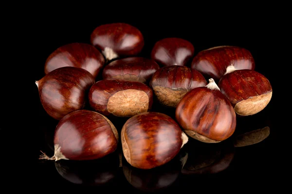 Chestnuts on a black reflective background — Stock Photo, Image