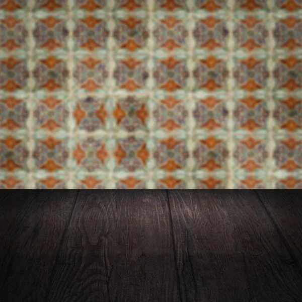 Wood table top and blur vintage ceramic tile pattern wall — Stock Photo, Image