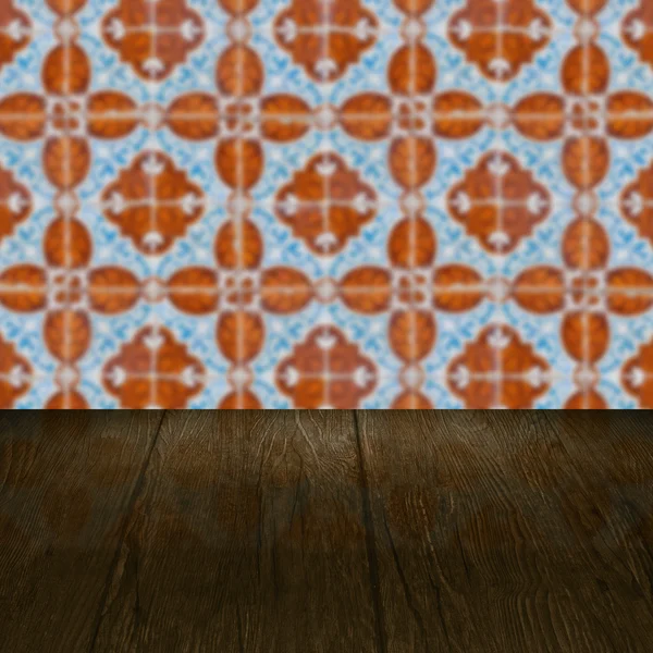 Wood table top and blur vintage ceramic tile pattern wall — Stock Photo, Image