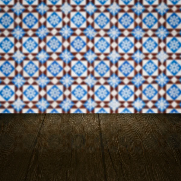 Wood table top and blur vintage ceramic tile pattern wall — Stock Photo, Image