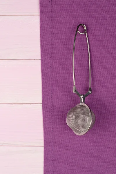 Kitchenware on purple towel — Stock Photo, Image
