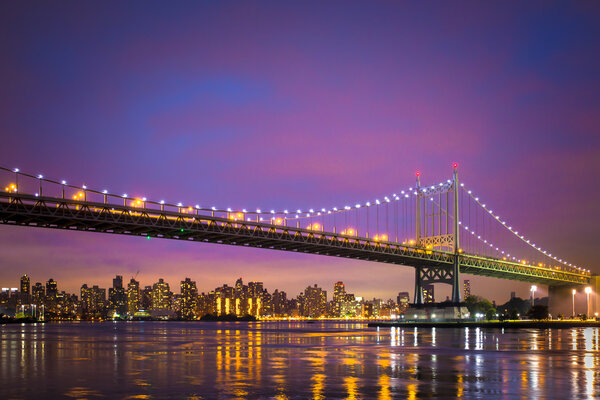 Colorful twilight view of New York City RFK Triborough Bridge and Manhattan