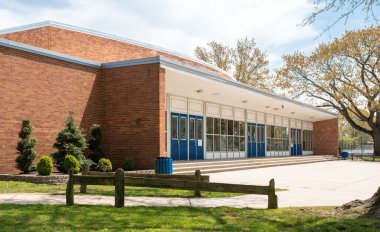 Exterior view of a typical American school building clipart