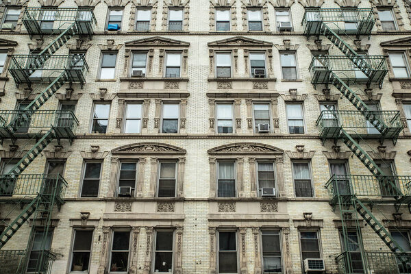 Apartment building exterior with windows and fire escapes New York City Manhattan