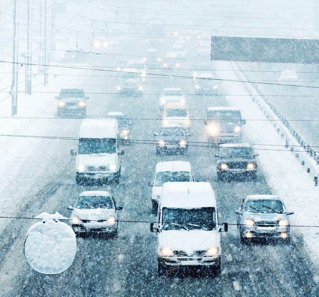 KIEV, UKRAINE - FEB 06: Rush hour - blizzard on the road and bad visibility on february 06 2015 in Kiev, Ukraine . All logos, numbers, recognizable trademarks removed