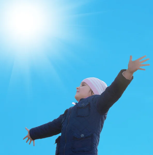 Happy little girl on blue sky  background Stock Photo