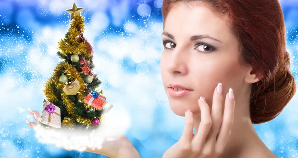 Beautiful Caucasian Women with green  Christmas eve tree over hand — Stock Photo, Image