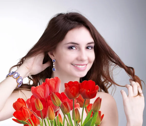 Schoonheid vrouw met mooi boeket verse rode tulpen — Stockfoto