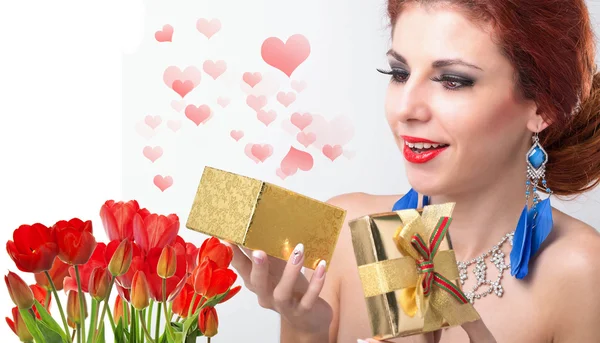 Beauty Woman with Beautiful bouquet fresh red tulips and gift — Stock Photo, Image