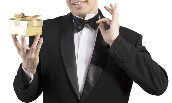 Man in classic tuxedo on white with gift box — Stock Photo, Image