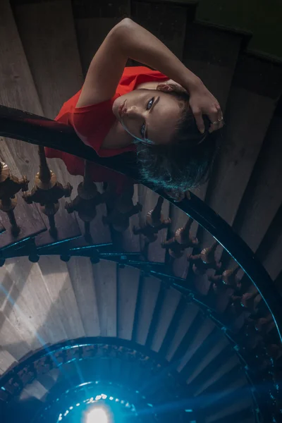 Pretty woman in red dress on the old stairs — Stock Photo, Image