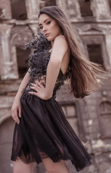 Beauty fashion woman wearing designer stylish dress in the abadoned town — Stock Photo, Image