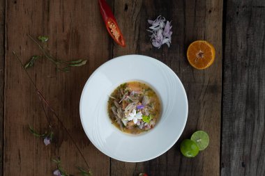 Üst manzara karidesler, beyaz levrek, mürekkep balığı, ahşap masada izole edilmiş portakal soslu somon balığı.
