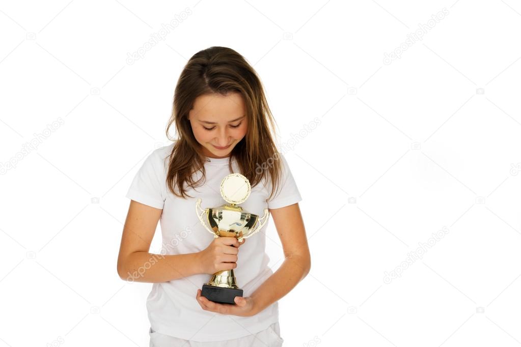 Young girl clasping a sporting trophy