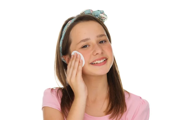 Young girl cleaning her face with a cotton pad — Stock Photo, Image