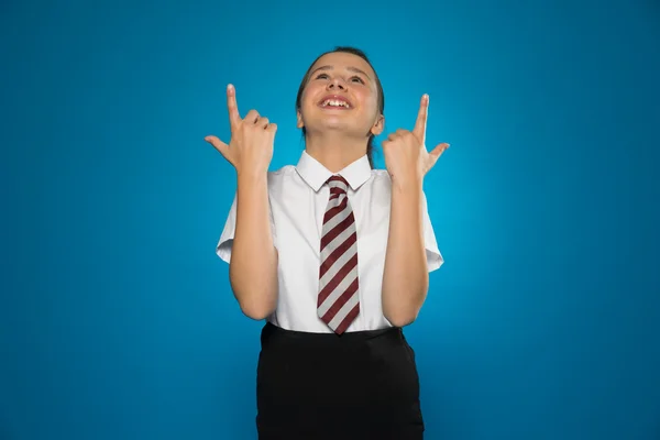 Happy young girl pointing above her head — Stock Photo, Image