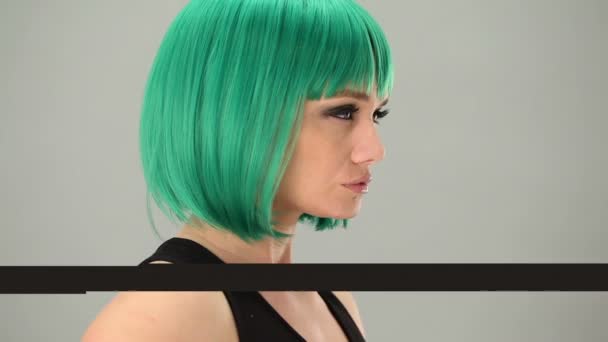 Thoughtful woman wearing a green wig — Stock Video