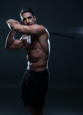 Gorgeous Shirtless Muscled Man Holding a Sword clipart