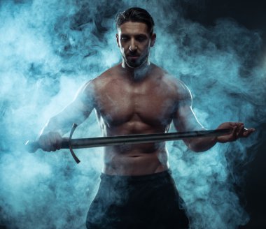 Gorgeous Shirtless Muscled Man Holding a Sword clipart