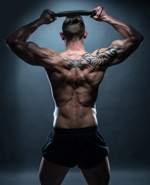 Fit Man with Exercise Bar on his Head in Rear View — Stock Photo, Image