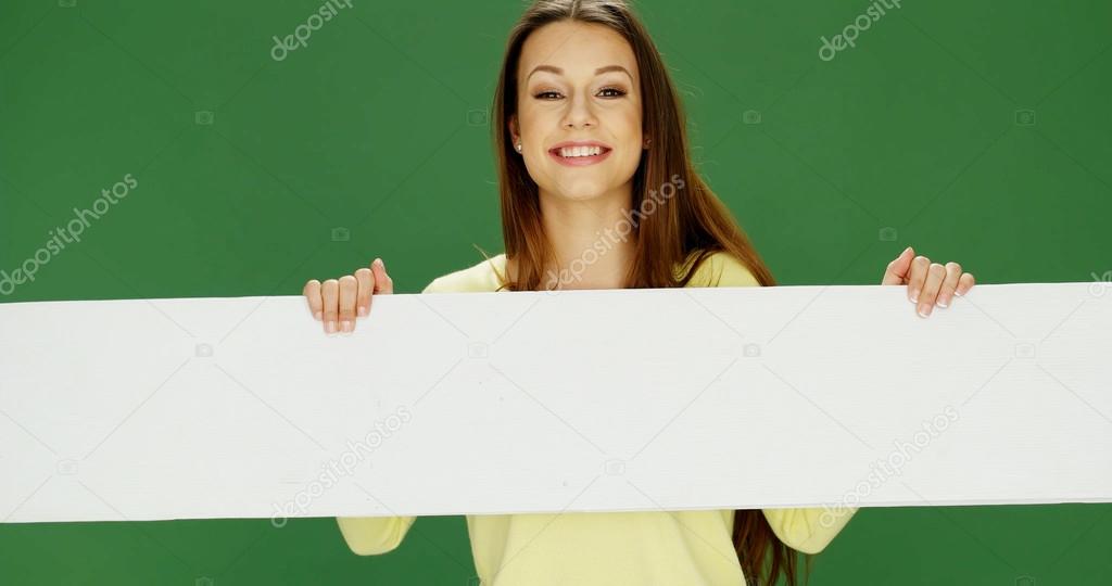 Smiling woman holding a long banner