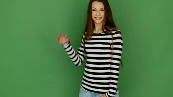 Happy Brunette Model Wearing Stripy Top on Green Background — Stock Video