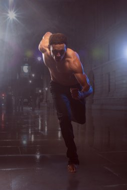 Athletic and muscular man is running I