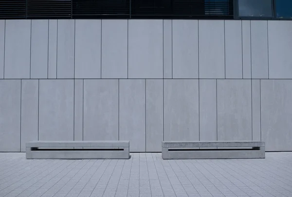 Two Similar Benches Against White Building Wall — Stok fotoğraf