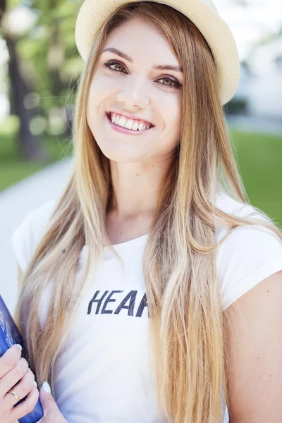 Mujer rubia bonita con sombrero sosteniendo un libro — Foto de Stock