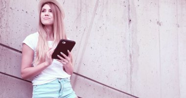 happy woman student holding a tablet