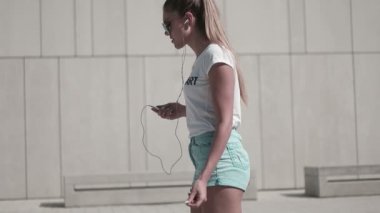 Fitness ve yaşam kavramı - spor yaparken ve müzik açık havada için bekleyen kadın
