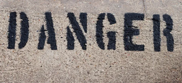 Danger word on the marble wall — Stock Photo, Image