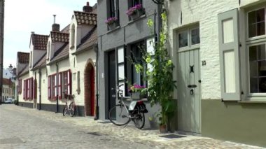 A quiet street with traditional houses in Bruges, Belgium.