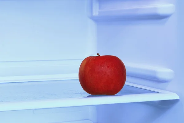 Pomme rouge au réfrigérateur domestique prise à huis clos. — Photo